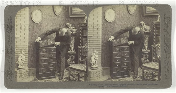 Building up an Underwood Patent Extension Stereograph Cabinet, - in a home Library, 1901. Creator: Underwood & Underwood.