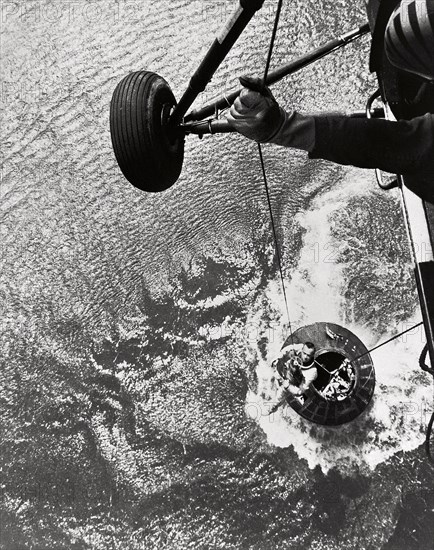 Shepard hoisted from Mercury capsule, 1961.  Creator: NASA.