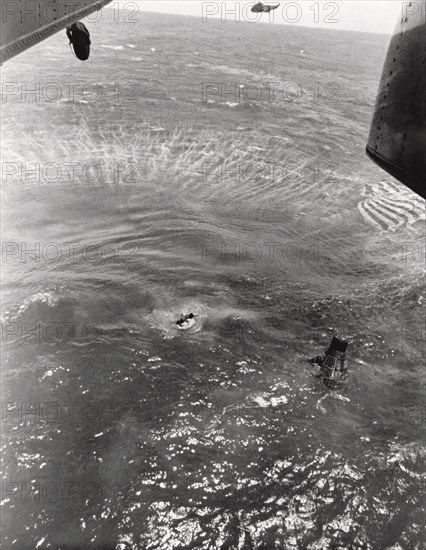 Navy frogmen swim to spacecraft to begin retrieval, Pacific Ocean, 1963. Creator: NASA.