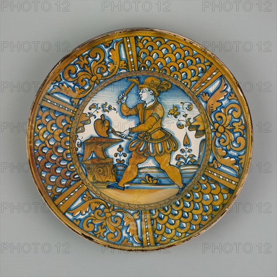 Display Plate with a Man Striking a Heart on an Anvil, Deruta, c. 1550. Creator: Unknown.