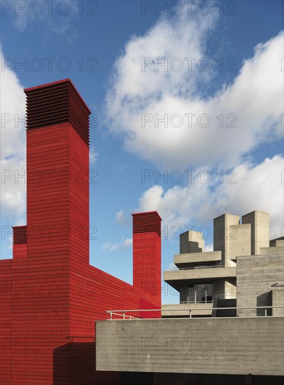 Royal National Theatre, Upper Ground, Southwark, London, 2014. General view of the tops of the red-painted wooden temporary theatre and the concrete Royal National Theatre building, from the south-west.