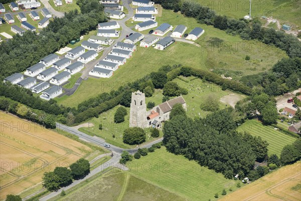 Static caravans and the Church of St Bartholomew, Corton, Suffolk, 2019. Creator: Historic England.