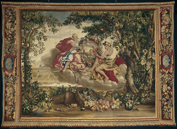 Autumn, from The Seasons, Paris, 1700/20. Diana and Bacchus float on a cloud, holding a floral wreath featuring a stag hunt. In the background is the Château de Saint-Germain-en-Laye, a royal retreat near Paris. Woven at the workshop of Etienne Le Blond and Jean de La Croix at the Manufacture Royale des Gobelins, after a design by Charles Le Brun.