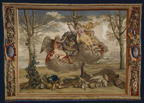 Winter, from The Seasons, Paris, 1700/20. Saturn (god of agriculture and time) and Juventas (cupbearer to the gods on Mount Olympus) floating on a cloud. Below are winter vegetables, a gun, nets and game from a hunt. In the background is the Palais du Louvre in Paris. Woven at the workshop of Etienne Le Blond and Jean de La Croix at the Manufacture Royale des Gobelins, after a design by Charles Le Brun.
