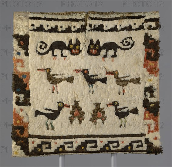 Feathered Tunic, Peru, 1470/1532. Cat and bird motif embellished with rare and valuable feathers from macaws, parrots, toucans, cotingas and tanagers from the tropical forests of South America, transported across the treacherous peaks of the Andes. The tunic was buried with its owner in dark, dry tomb which preserved its bright colours.