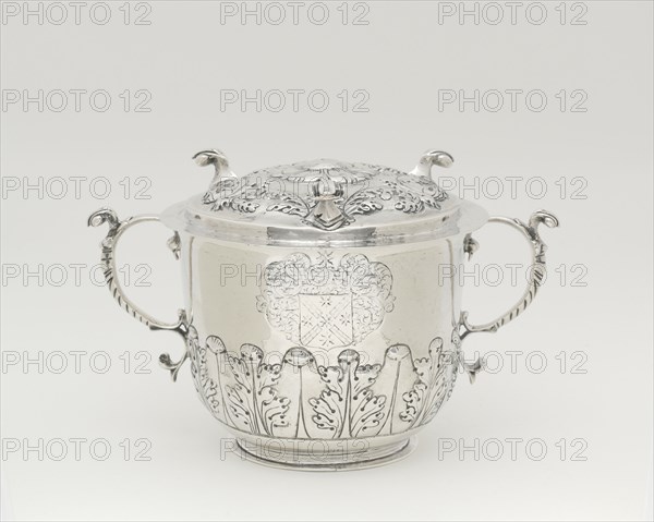 Two-Handled Covered Cup, 1698/1720. Silver cup with lid, two handles with leaf designs, used to serve syllabub, a sweetened or flavoured wine, cider, beer, or ale into which milk was whipped. Scroll-like handles, acanthus-leaf ornament.