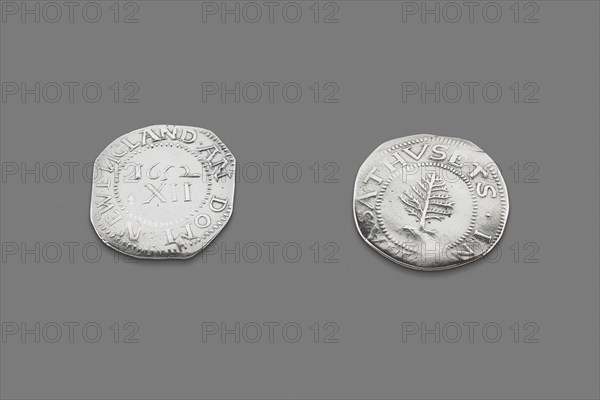 Pair of Pine Tree Shillings, 1663/82. Coins minted and circulated in the thirteen colonies of North America. The words NEW ENGLAND AN DOM on one side, IN MASATHVSETS and a pine tree on the other. Although the coins were produced every year until 1682, all were stamped with the date of the founding of the mint: 1652.