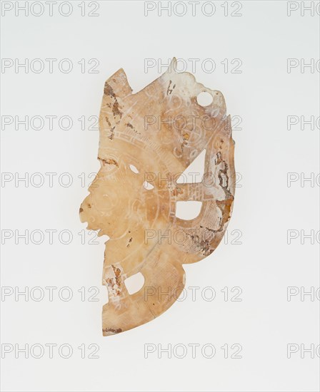 Carved Shell Depicting the Profile Face of Diety (Broken), A.D. 250/900.