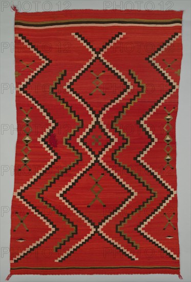 Sarape with Terraced Zigzag Design, 1865/85. A work made of wool, plain weave and dovetail tapestry weave; twined warp ends and selvages; looped and knotted corner tassels.