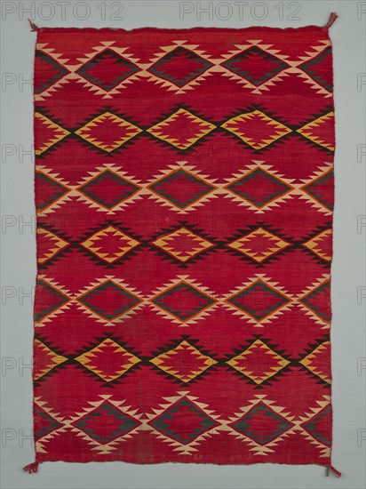 Sarape with Serrated Diamond Pattern, 1880/1900. A work made of wool, plain weave with "lazy lines" and dovetail tapestry weave; twined warp ends and selvages; looped and knotted corner tassels.