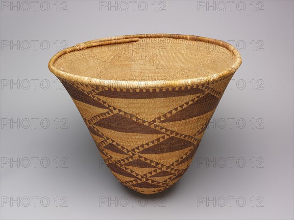 Burden Basket, 1870/80. Large tan woven basket with dark brown triangles.