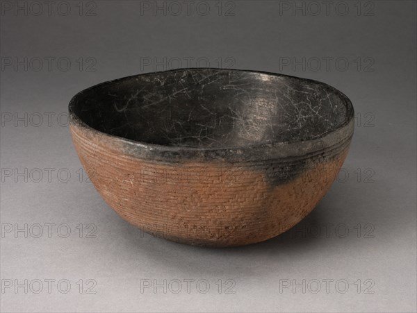 Bowl with Textured Surface Decoration in Basketry-Like Pattern, A.D. 900/1000. Round, red-brown bowl with small cracks its black interior. The outer surface is striated with tight horizontal lines and a diagonal pattern.