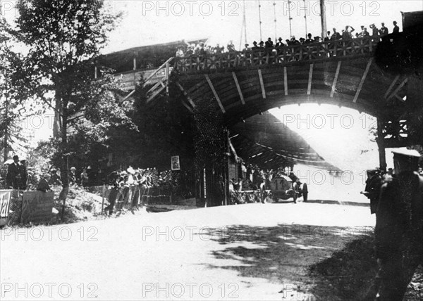 FIAT of Luigi Storero going under a bridge during the 1904 Gordon Bennett Cup, Homburg, Germany. Creator: Unknown.