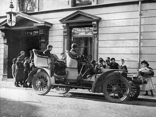 Claude Johnson behind the wheel of a 1905 Rolls-Royce 20hp. Creator: Unknown.