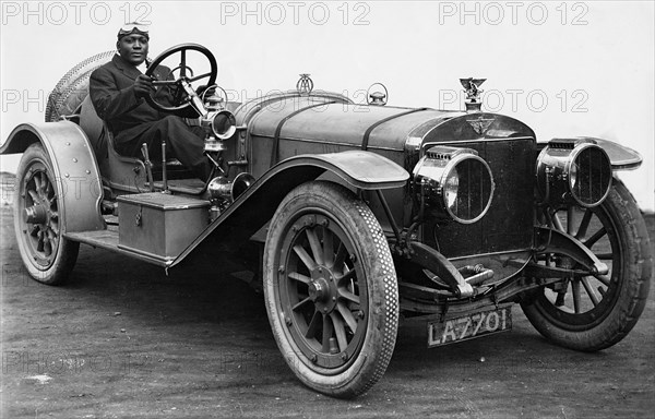 American world heavweight boxing champion Jack Johnson in a 1908 Austin 100hp Creator: Unknown.