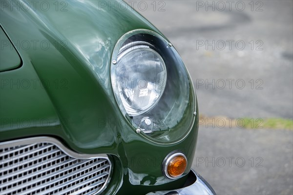 Left front headlight of a 1961 Aston Martin DB4 GT previously owned by Donald Campbell. Creator: Unknown.