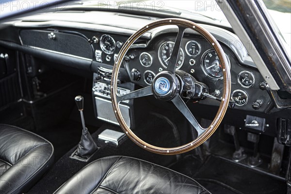 Steering wheel and dashboard of a 1965 Aston Martin DB5. Creator: Unknown.