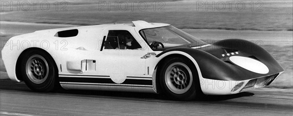 British racing driver and engineer Ken Miles driving a 1966 Ford GT40 J racing car. Creator: Unknown.