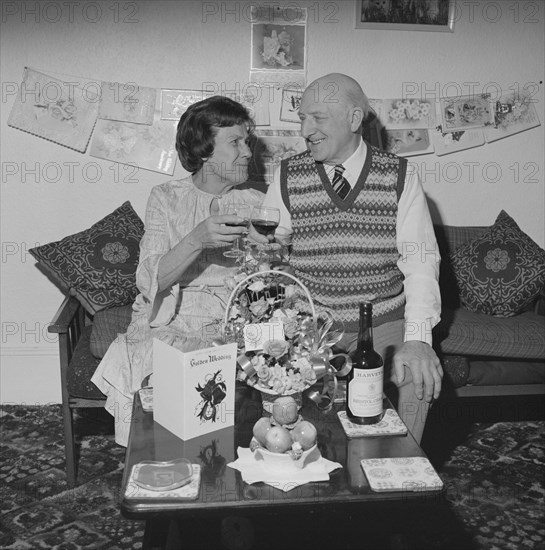 Mr and Mrs Birtmead toasting to their golden wedding anniversary, 26/04/1984. Creator: John Laing plc.