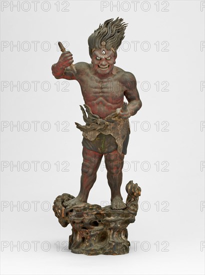 Shukongojin, Kamakura Period, 12th/14th century. A wooden sculpture of a muscular red figure with flaming hair and a third eye, stares fiercely down at us. Left head raised over head holds a vajra, a ritual object.