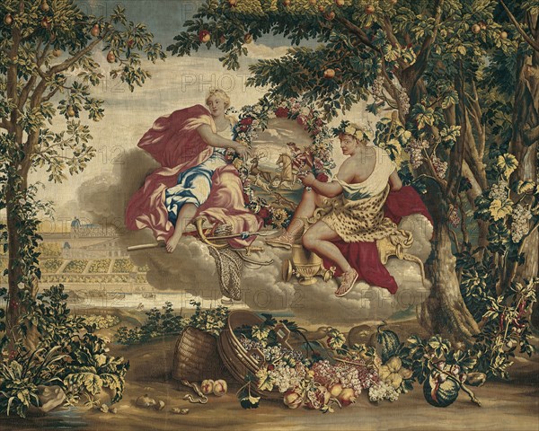 Autumn, from The Seasons, Paris, 1700/20. Diana and Bacchus float on a cloud, holding a floral wreath featuring a stag hunt. In the background is the Château de Saint-Germain-en-Laye, a royal retreat near Paris. Woven at the workshop of Etienne Le Blond and Jean de La Croix at the Manufacture Royale des Gobelins, after a design by Charles Le Brun. Detail from a larger artwork.