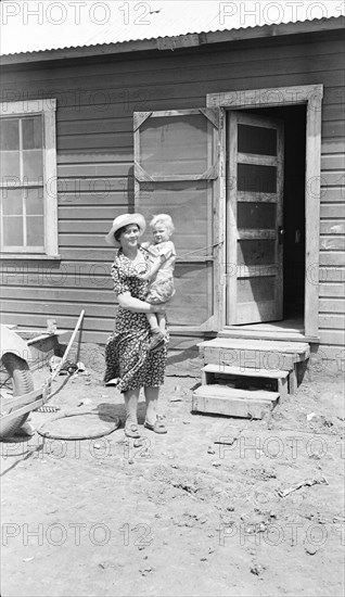 Typical Teutonic farm wife and child of Mills, New Mexico, area, 1935. Creator: Dorothea Lange.