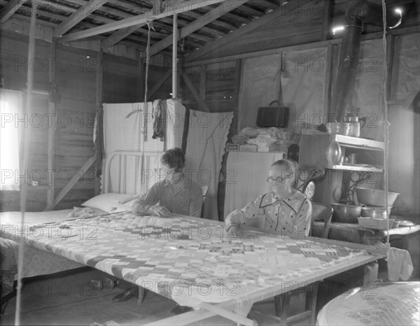 Grandmother from Oklahoma with grandson, working on quilt, California, Kern County, 1936. Creator: Dorothea Lange.