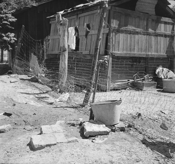 Home of Mexican field worker showing water supply, Brawley, Imperial Valley, California, 1935. Creator: Dorothea Lange.