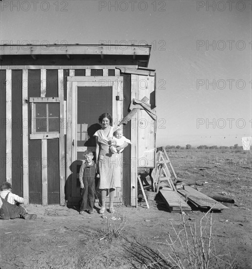 Resettled at Bosque Farms project - family of four from Taos Junction, 1935. Creator: Dorothea Lange.