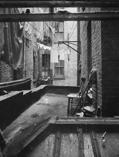 Out of rear window tenement dwelling of Mr and Mrs Jacob Solomon, 133 Avenue D, New York City, 1936. Creator: Dorothea Lange.