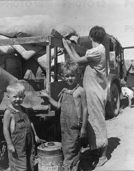 Part of an impoverished family of nine on a New Mexico highway, 1936. Creator: Dorothea Lange.