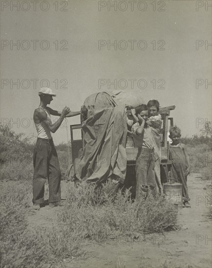 A tubercular painter from Iowa and part of his family... penniless in New Mexico, 1937. Creator: Dorothea Lange.