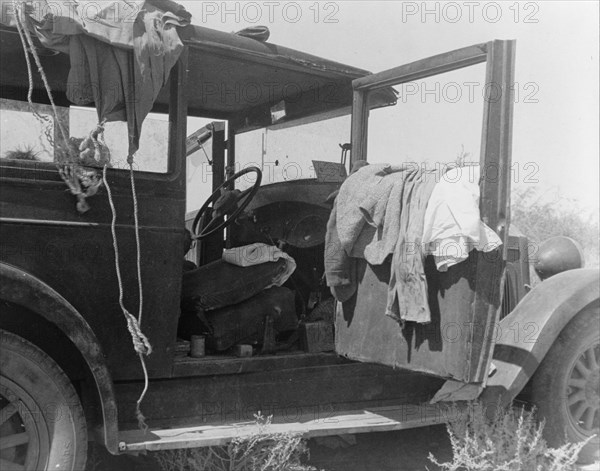 The only home of a depression-routed family of nine from Iowa, 1936. Creator: Dorothea Lange.