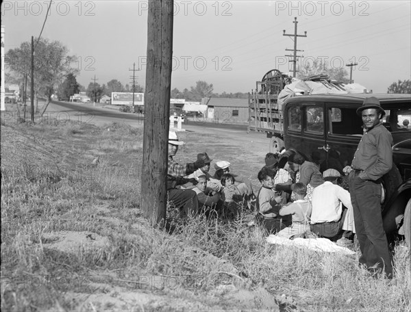 Mexicans bound for the Imperial Valley to harvest peas, near Bakersfield, California, 1936. Creator: Dorothea Lange.