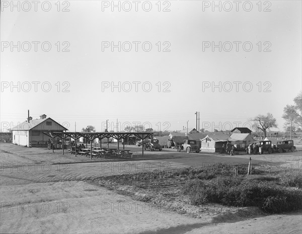 View of Kern migrant camp showing outdoor clubroom with protection from the sun, California, 1936. Creator: Dorothea Lange.