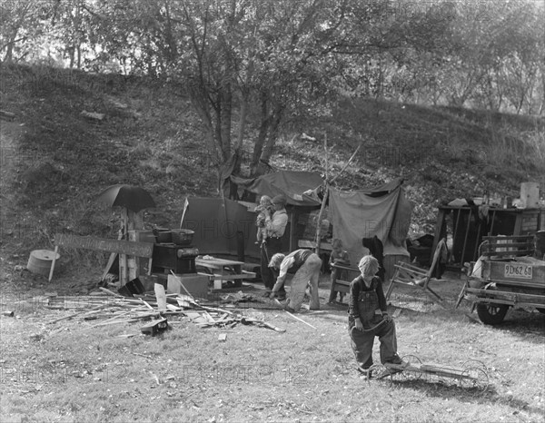 Destitute family, American River camp, near Sacramento, California., 1936. Creator: Dorothea Lange.