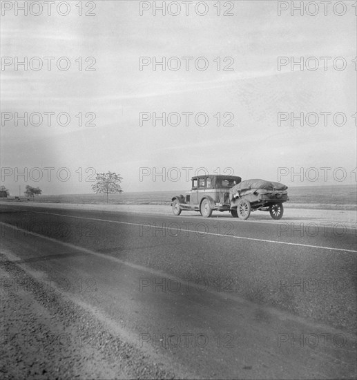 Migrant family on U.S. Highway 99 between Bakersfield and Famoso, California, 1936. Creator: Dorothea Lange.