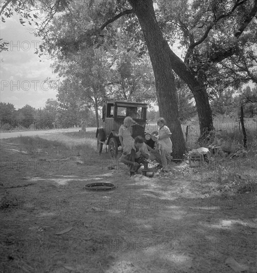 Migrant family from Oklahoma in Texas, alongside the road, 1936. Creator: Dorothea Lange.