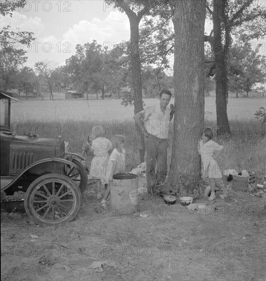Migrant family from Oklahoma in Texas, alongside the road, 1936. Creator: Dorothea Lange.