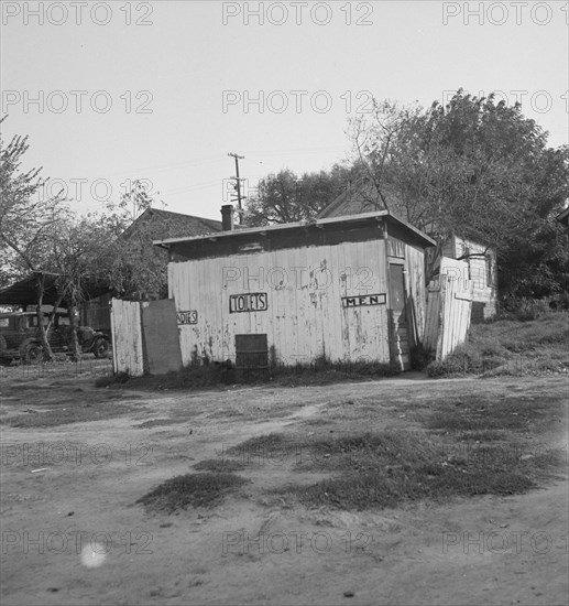 Privy in cheap migratory camp, San Joaquin Valley, California, 1936. Creator: Dorothea Lange.