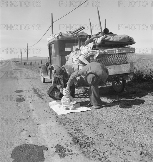 Missouri family of five on U.S. Highway 99 near Tracy, California, 1937. Creator: Dorothea Lange.