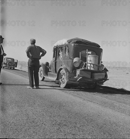 Migrant from Chickasaw, Oklahoma, stalled on the desert in southern California with no money, 1937. Creator: Dorothea Lange.