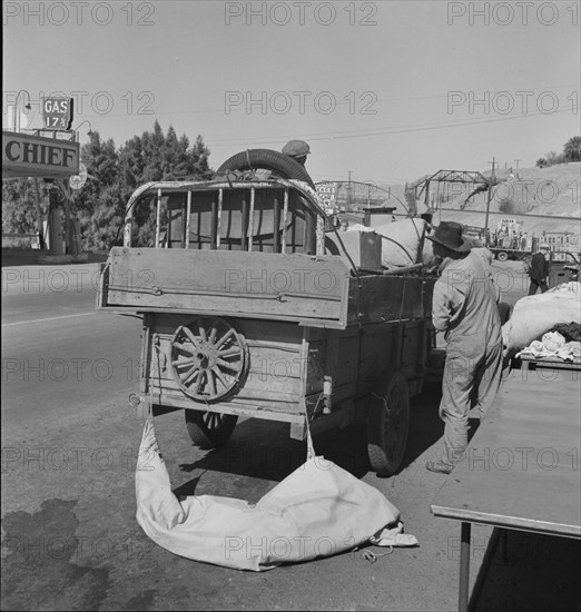 Drought refugees stopped at inspection station on the California-Arizona state line, 1937. Creator: Dorothea Lange.