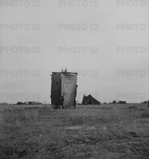 Unsanitary privy in potato pickers' camp near Shafter, California, 1937. Creator: Dorothea Lange.