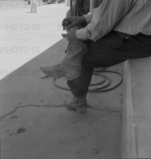 A Texas cattleman is distinguished by the type of boot he wears, Van Horn, Texas, 1937. Creator: Dorothea Lange.