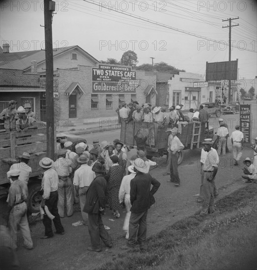 Truck loads of cotton hoers going from Memphis, Tennessee into Arkansas, 1937. Creator: Dorothea Lange.