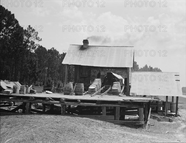 Turpentine still in the Piney Woods near Valdosta, Georgia, 1937. Creator: Dorothea Lange.