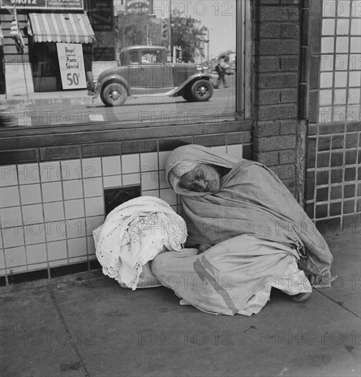 She awaits the international streetcar at a corner in El Paso, Texas to return across..., 1938. Creator: Dorothea Lange.