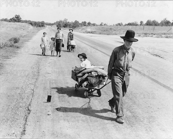 Family walking on highway, five children, Pittsburg County, Oklahoma, 1938. Creator: Dorothea Lange.