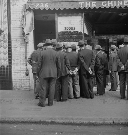 In front of the local paper of San Francisco's Chinatown, 1938. Creator: Dorothea Lange.